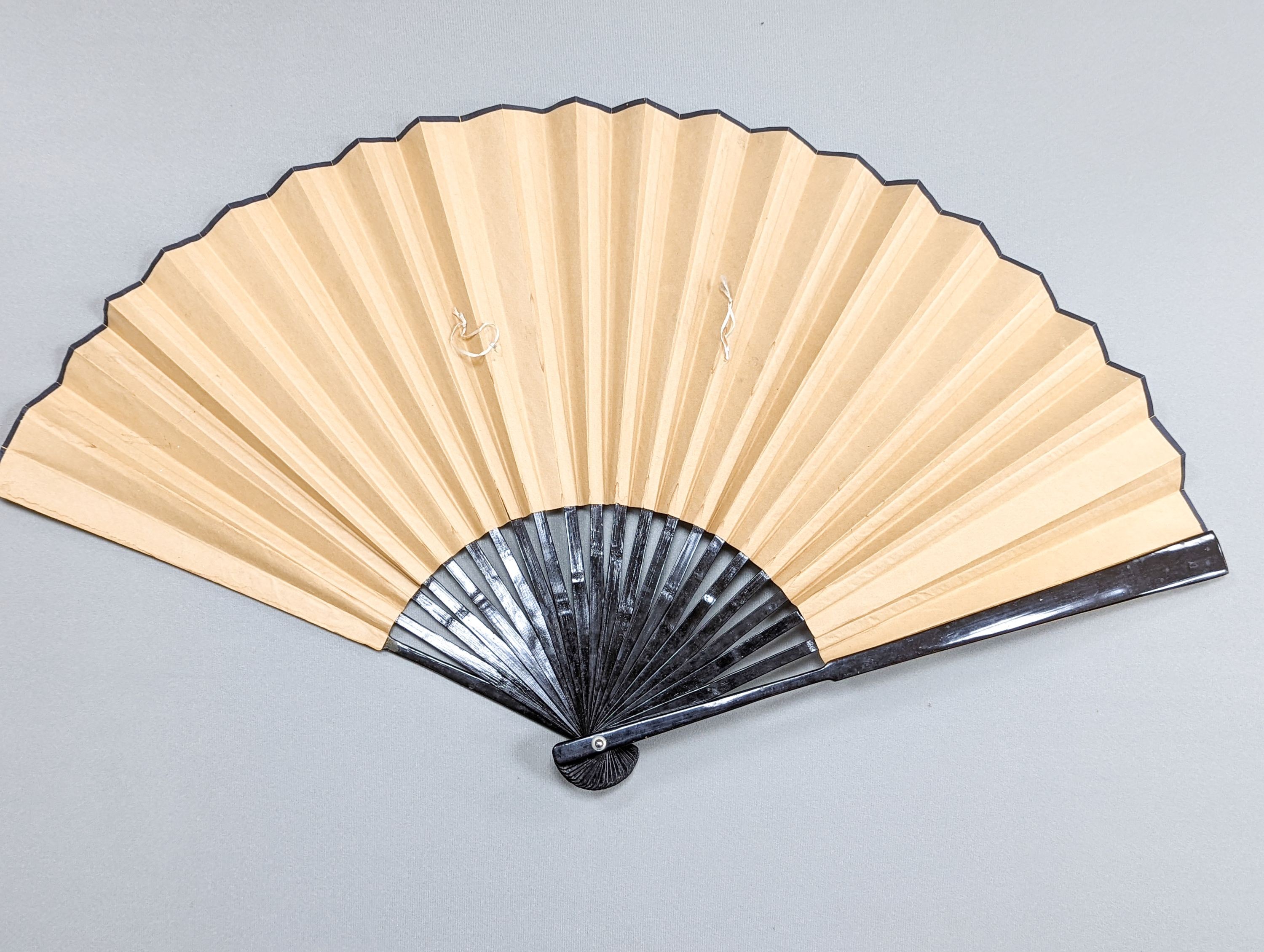 A large Chinese fan, the leaf painted with a landscape, signed Radius 60cm